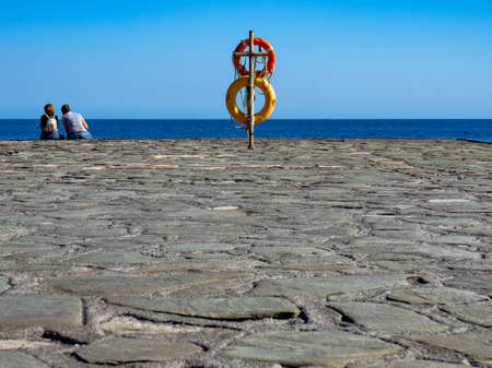 Small port in El Hierro. We can see a lifeguard and in the background a couple.の写真素材