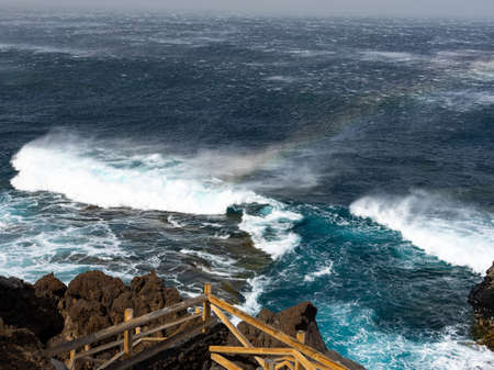 Swell in the Charco de Los Sargos, El Hierro. The waves produces a rainbow.の写真素材