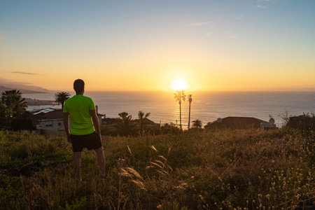 Runner watching the sunset from Tenerife. The Atlantic ocean is observed.