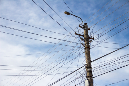 Lamp post with many cables that run in different directionsの写真素材