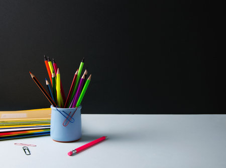 Goods for school, office lie on a blue background. Notebook, pencils, markers and other goods, flat layout, copying text, selective focusの写真素材
