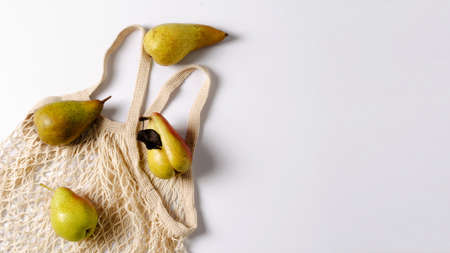 Pears Conzference and Trout on an eco-sup and white background. The concept of eco-products with a copy of space and a flat layoutの写真素材