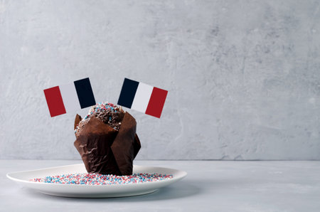 Chocolate cupcake with French flags. National Bastille Day Celebration July 14 with a copy of the...