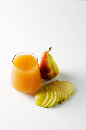Pear juice in a transparent glass on a white background, copying space, top viewの写真素材