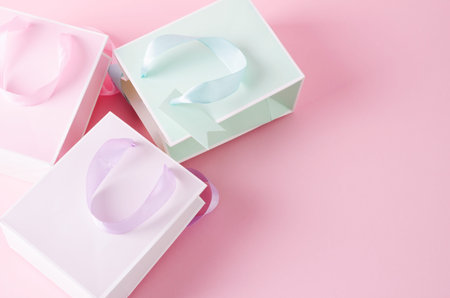 Pastel paper bags on pink. Holiday Shopping, Gift Wrapping, Selective Focus