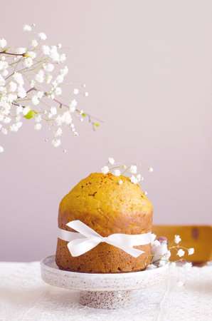 Handmade easter cake with white flowers and decor on table, spring celebration concept