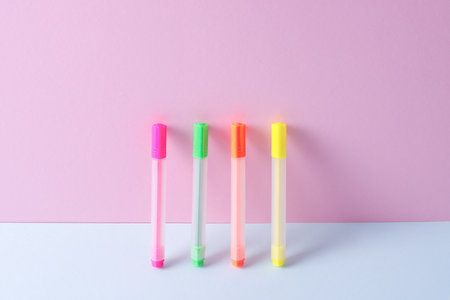 Colored markers stand on a pink background, the concept of the background Coming soon to school, markers for drawingの写真素材