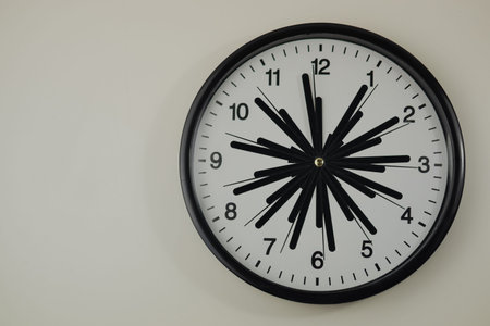Black and white clock with many arrows on white background
