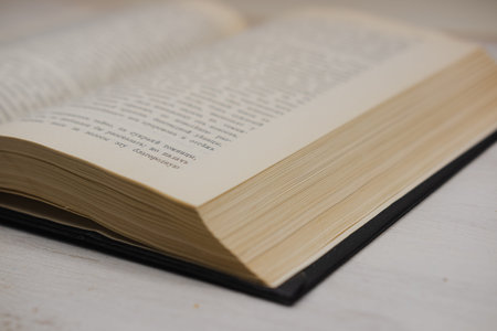 Open old book on white background