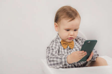Little boy looking at phoneの写真素材