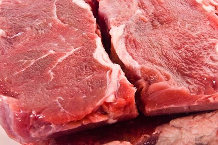 Fresh meat pieces on white dishの写真素材