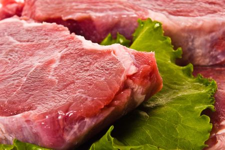 Fresh meat pieces on white dishの写真素材