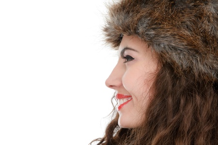 Beautiful woman in fur hat studio isolated on white backgroundの写真素材