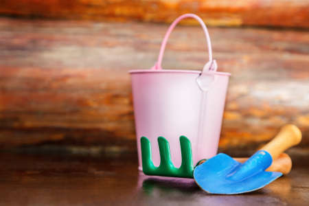 Garden tools photo against wooden wallの写真素材