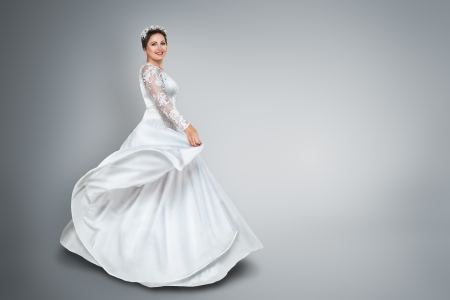 Happy young bride in beautiful long wedding dressの写真素材