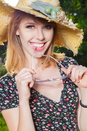 Happy young woman in sun hat outdoor portraitの写真素材