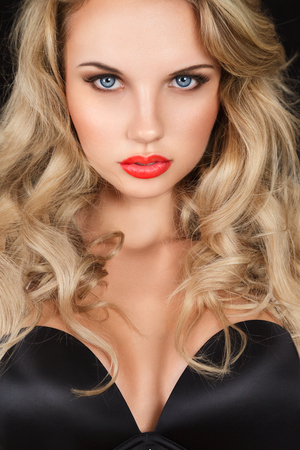 Beautiful blonde young woman with long hair studio portraitの写真素材