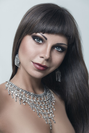 Young woman posing with Indian style necklace and earringsの写真素材