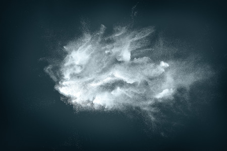 Abstract design of white powder cloud against dark backgroundの写真素材