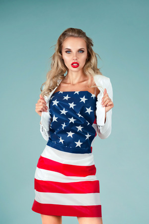Beautiful pin-up style fashion model in dress made from american flagの写真素材