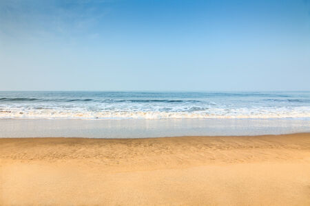 Empty deserted beach with clean blue skyの写真素材
