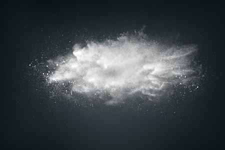 Abstract design of white powder cloud against dark backgroundの写真素材