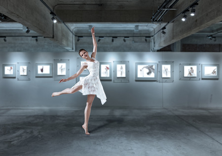 Beautiful young ballet dancer dancing at art galleryの写真素材