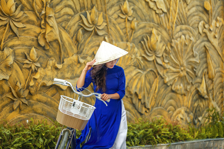 Portrait of young asian woman in traditional vietnamese dress ao dai in Vietnamの写真素材