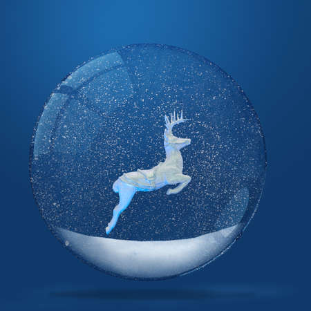 Deer inside of snowy snow globe over blue backgroundの写真素材
