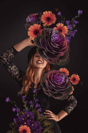 A beautiful young woman, fashion portrait with flowers surrounding her.の写真素材