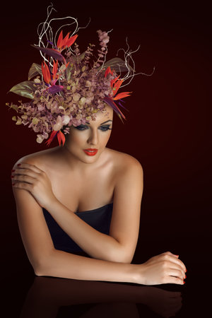 Artistic beauty woman portrait with flower arrangement. for fashion, beauty, spring campaigns, wedding aesthetics, and feminine lifestyle content.の写真素材