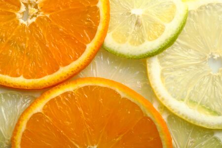 Slices of oranges, lemons and limes viewed from aboveの写真素材
