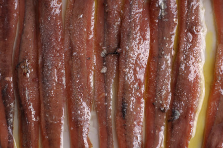 Close-up detail of a portion of canned Cantabrian anchovies (from SantoÃ±a) with olive oil