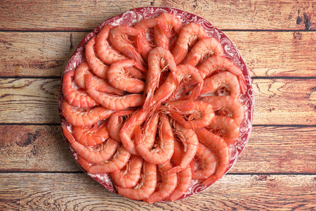 Portion of white prawns from Huelva on wooden tableの写真素材