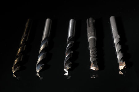 Presentation with various drill bits on black background