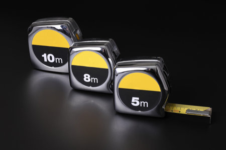 Flexometers or measuring tapes on black background