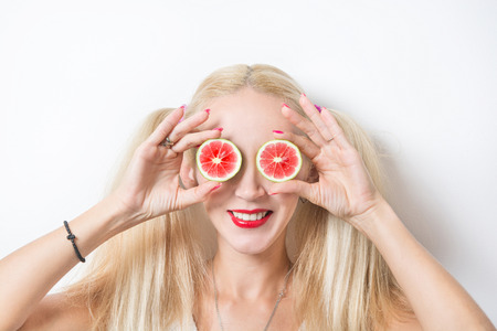 young girl plays with lemon wedgesの写真素材