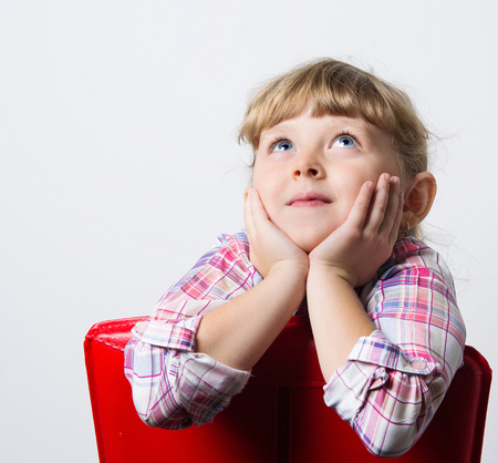 child dreams on a red chairの写真素材