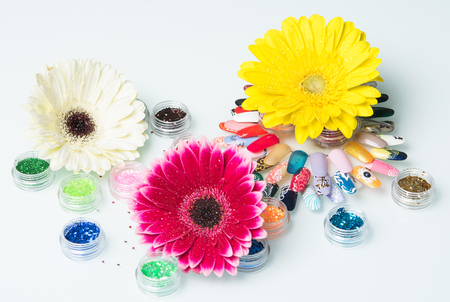 three brightly colored flower manicure setの写真素材