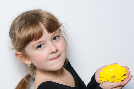 flower in the hands of a young girlの写真素材