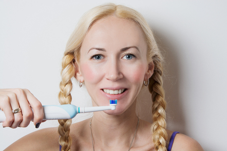 girl with pigtails brushing her teethの写真素材