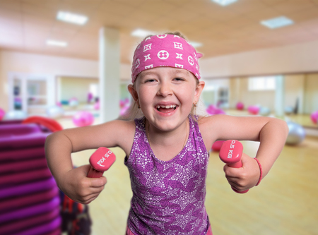 cheerful young athlete with dumbbellsの写真素材