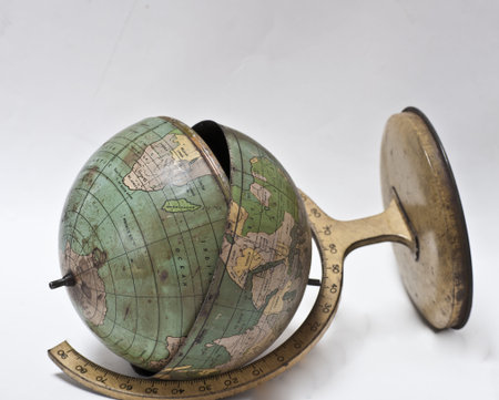 Vintage metal world globe lies cracked and brokenの写真素材