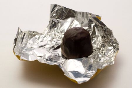 Chocolates in foil on a white backgroundsの写真素材