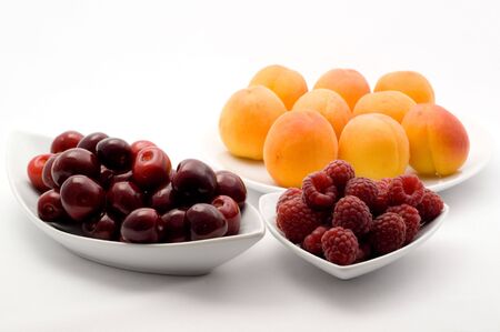 Apricots, raspberries and cherriesの写真素材