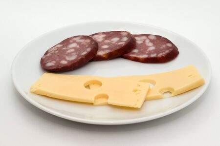 Sausage and cheese on a plate on a white backgroundの写真素材