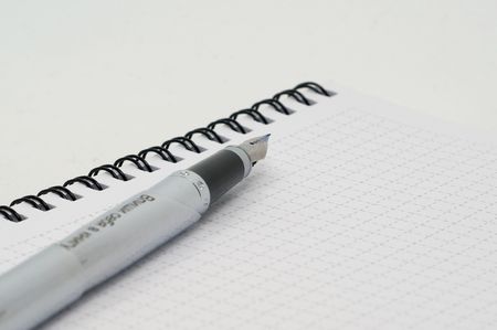 Rollerball pen with the pen is on the disclosure of open Notepadの写真素材