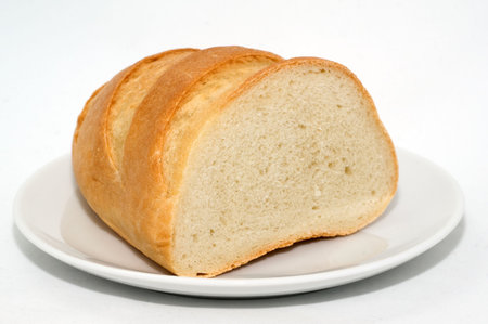 Wheat bread on a plate on a white background