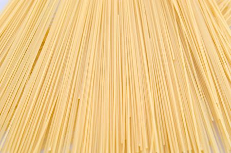 Noodless (spaghetti, pasta) made from wheat flour on a white backgroundの写真素材