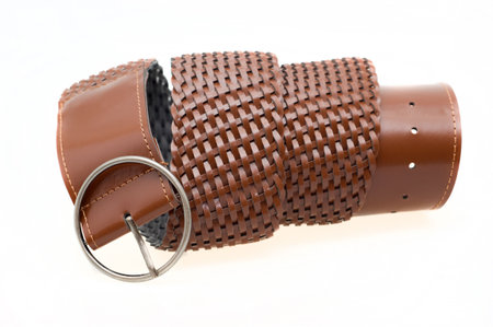 Women's braided brown leather belt with buckle on a white backgroundの写真素材